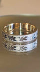 A wedding ring decorated with maple leaves